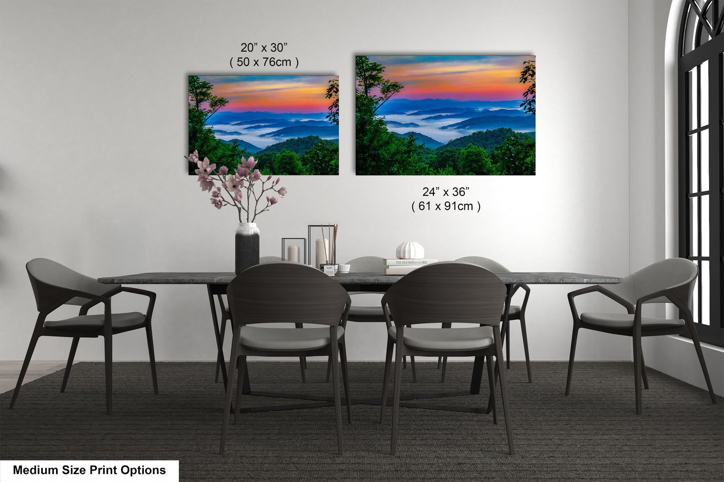 a dining table with four chairs and a vase of flowers
