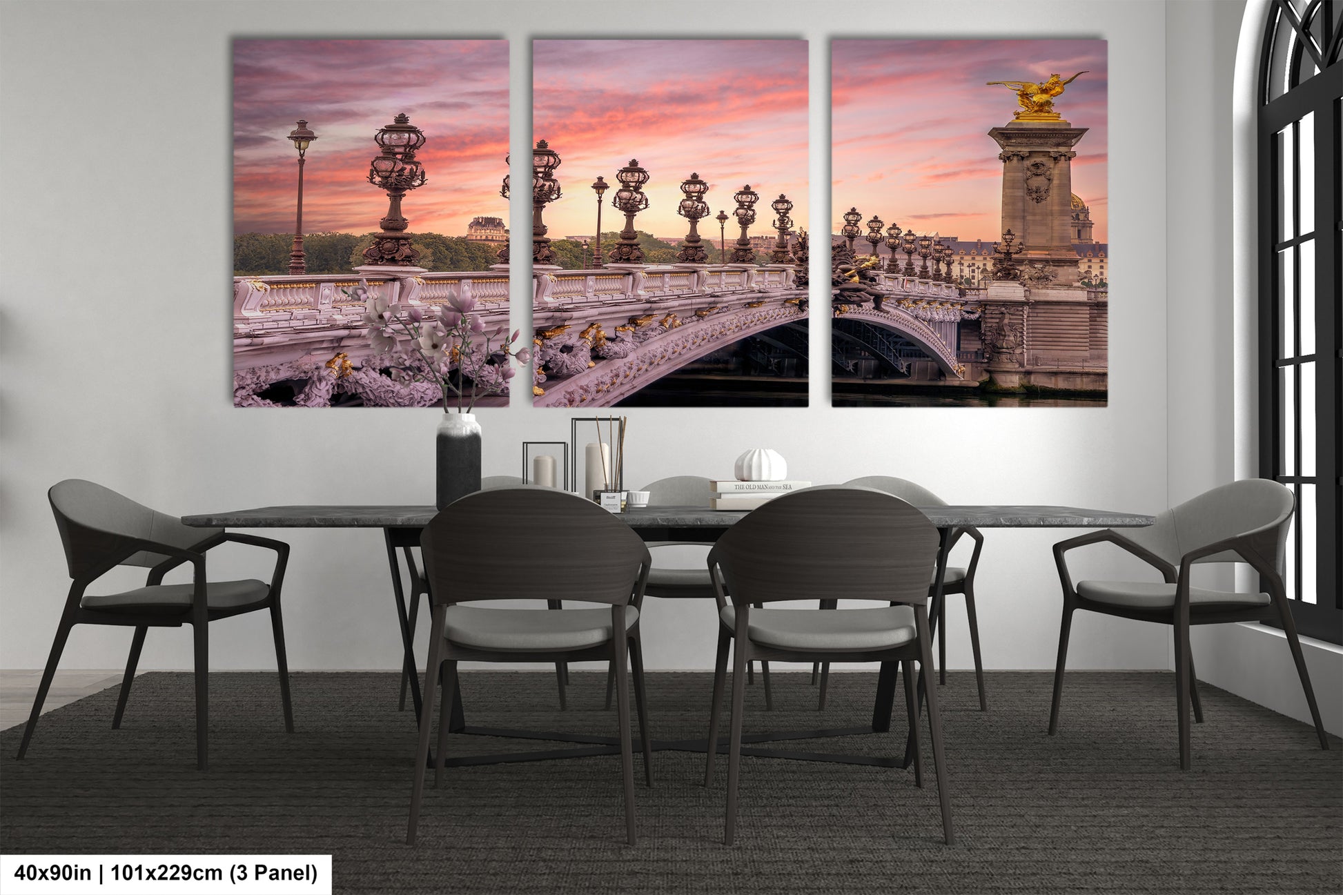 a dining room table with chairs and a painting on the wall