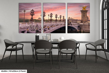 a dining room table with chairs and a painting on the wall