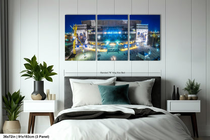 a bed room with a neatly made bed and two paintings on the wall