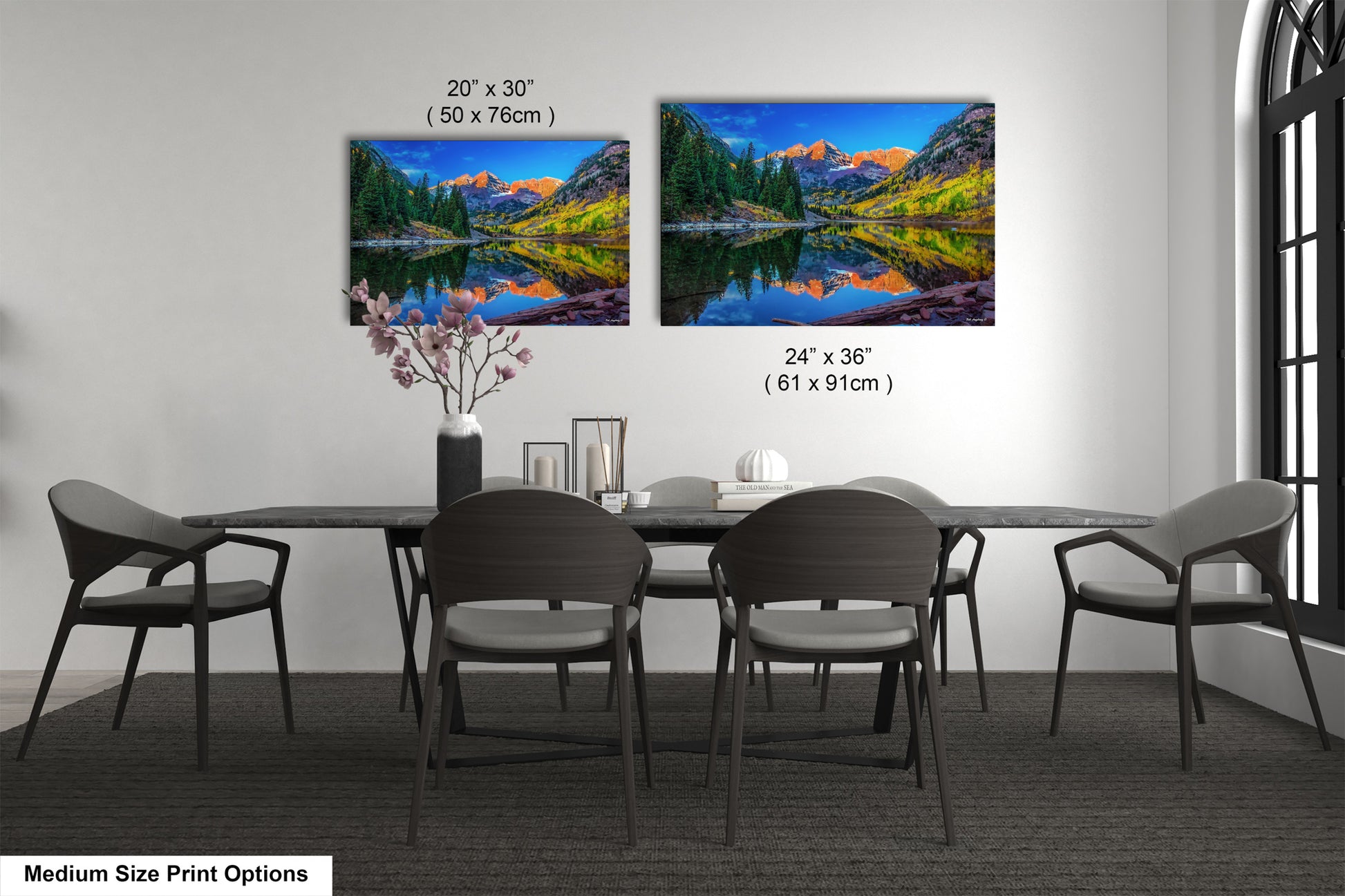 a dining room table with four chairs and a painting on the wall
