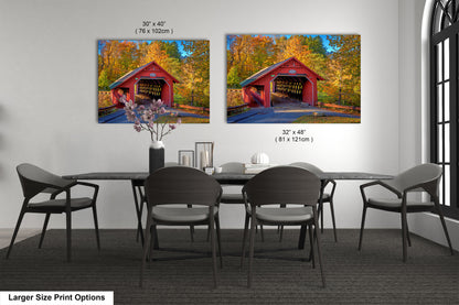 a dining room table with chairs and a painting of a covered bridge