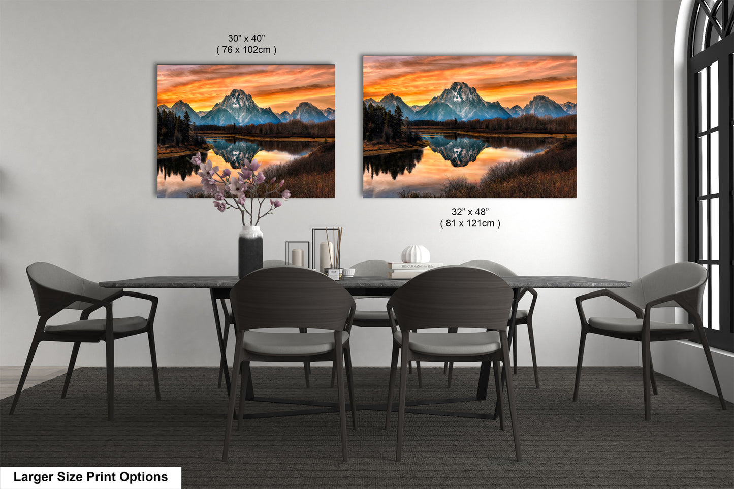 a dining room table with four chairs and a painting on the wall