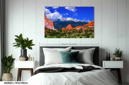 a bed in a room with a large picture on the wall