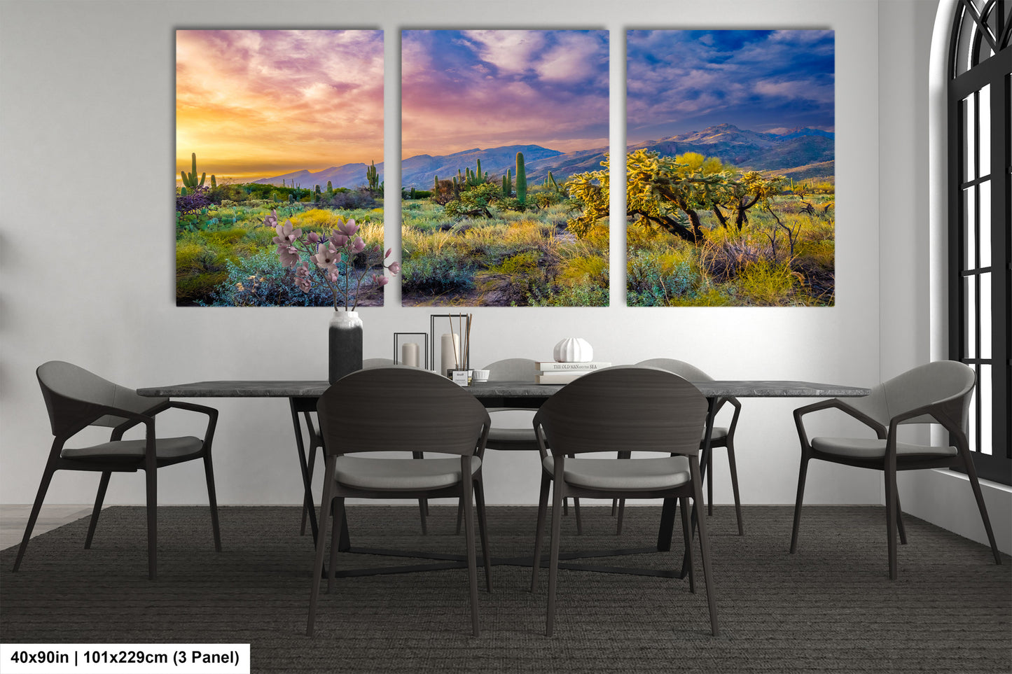 a dining room table with chairs and a painting on the wall