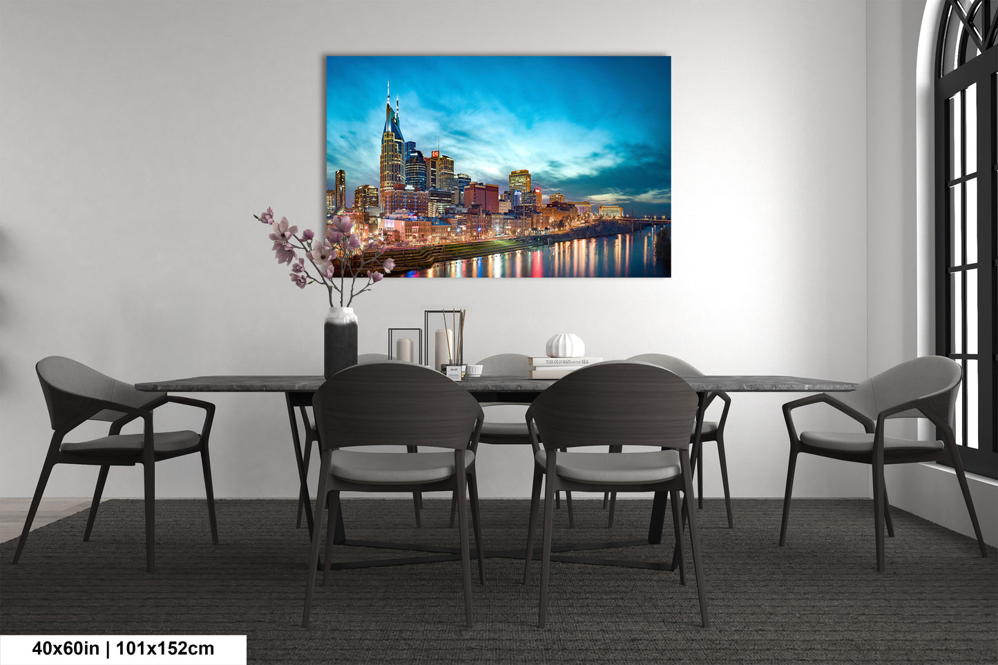 a dining room table with chairs and a painting on the wall