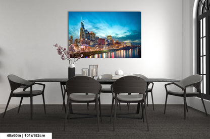 a dining room table with chairs and a painting on the wall
