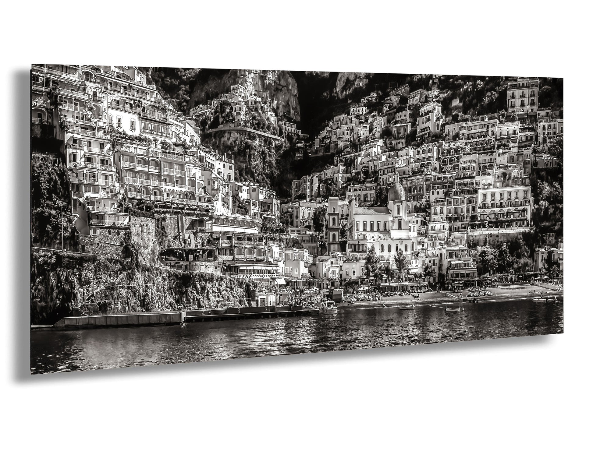 a black and white photo of a city by the water