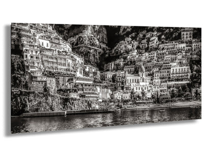 a black and white photo of a city by the water