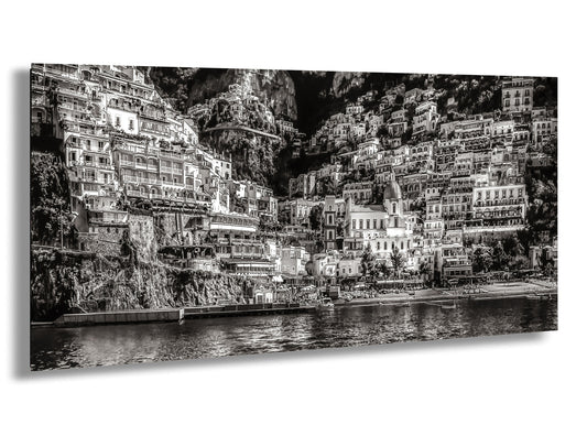 a black and white photo of a city by the water