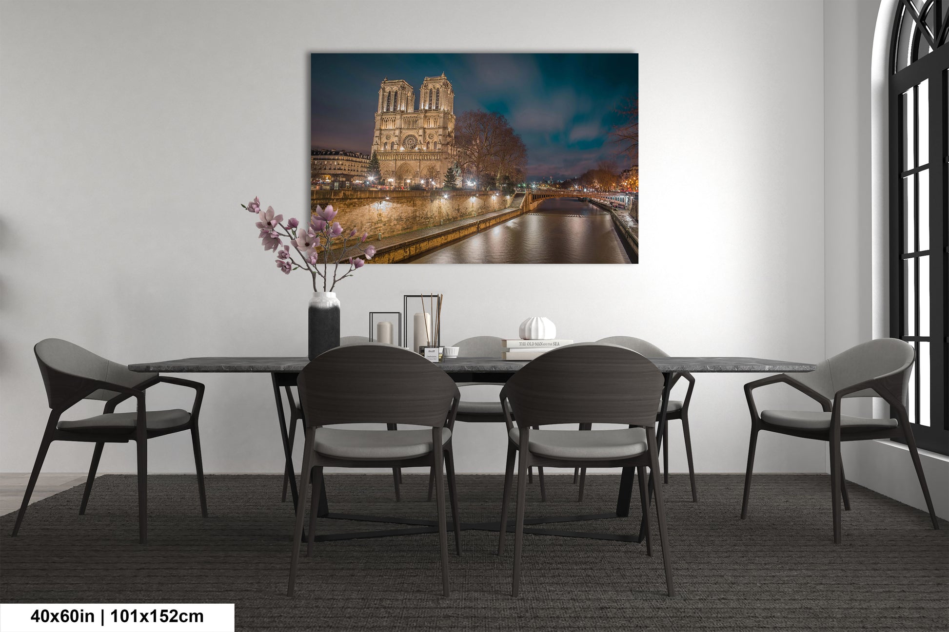 a room with a table and chairs and a painting on the wall