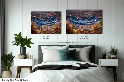 a bedroom with a large bed and two pictures on the wall