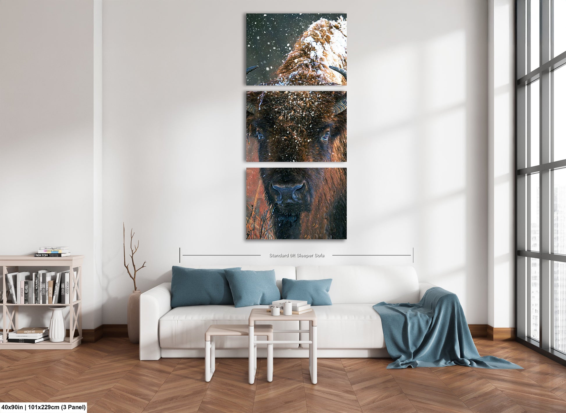a living room with a white couch and three paintings on the wall