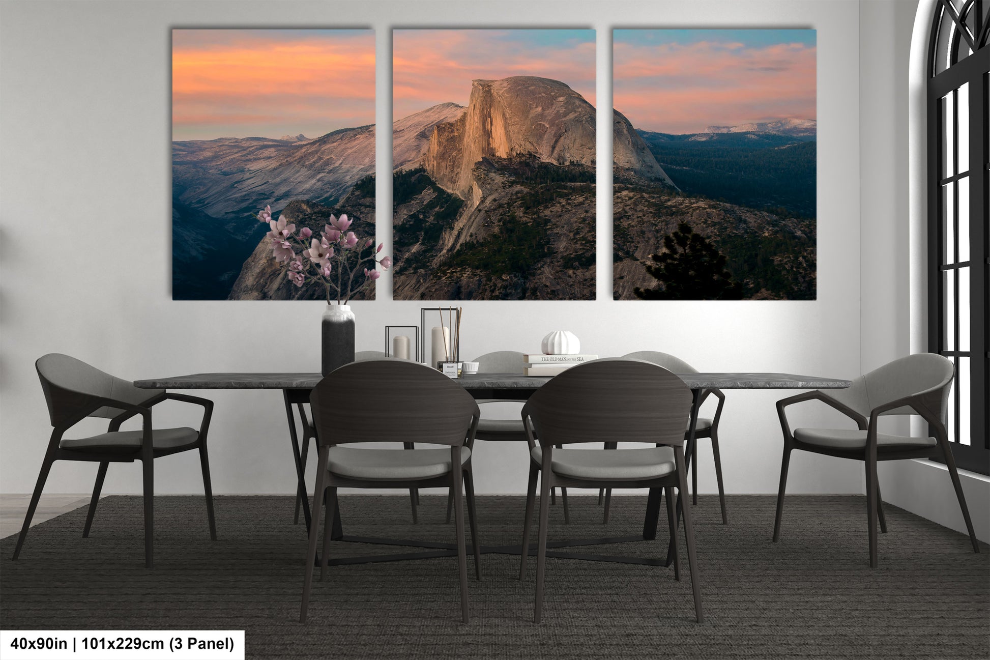 a dining room table with four chairs and a mountain in the background