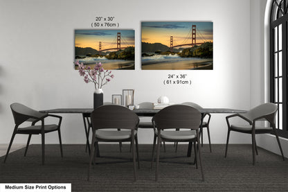a dining room table with four chairs and a vase of flowers