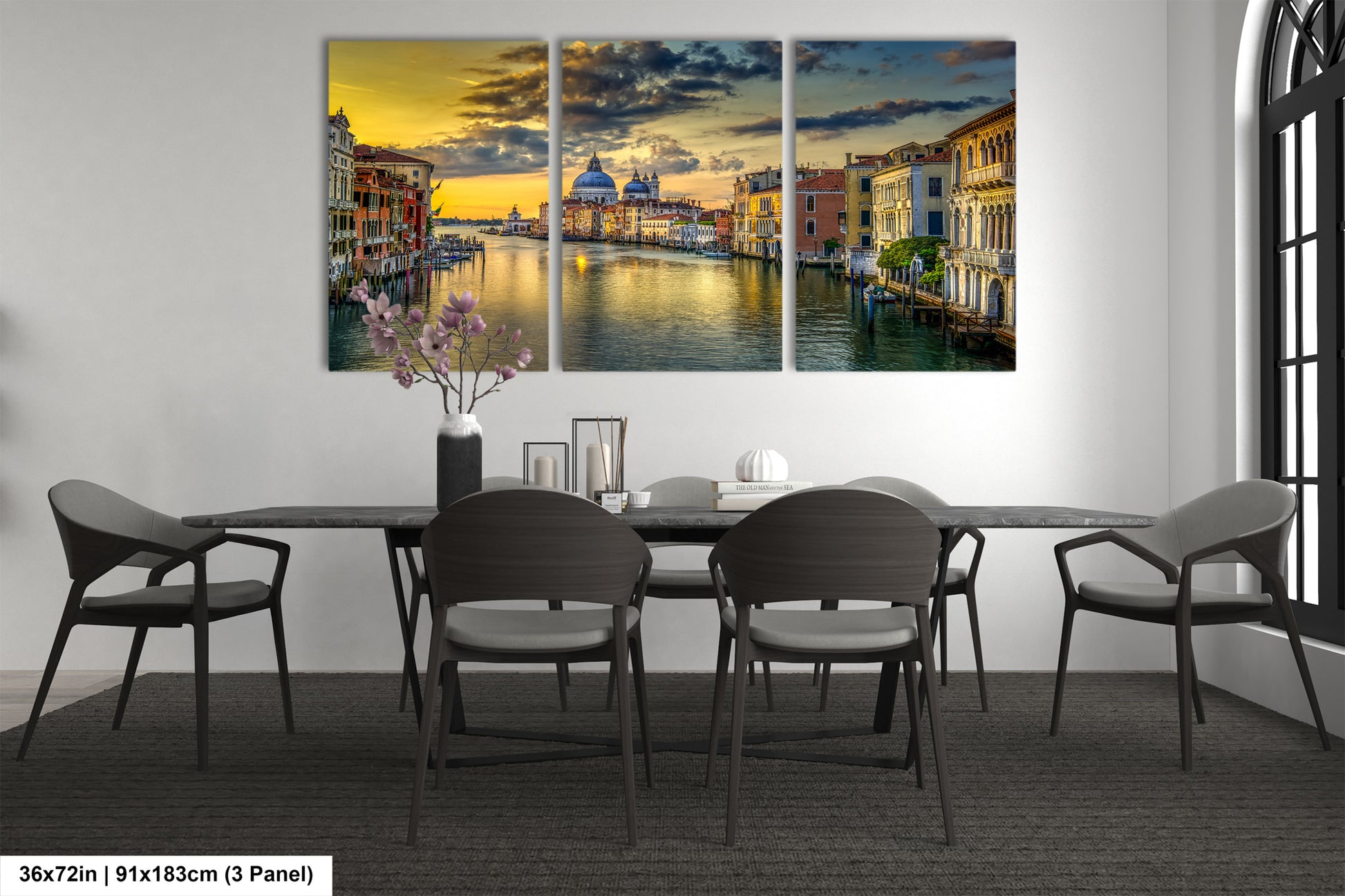 a dining room table with chairs and a painting on the wall