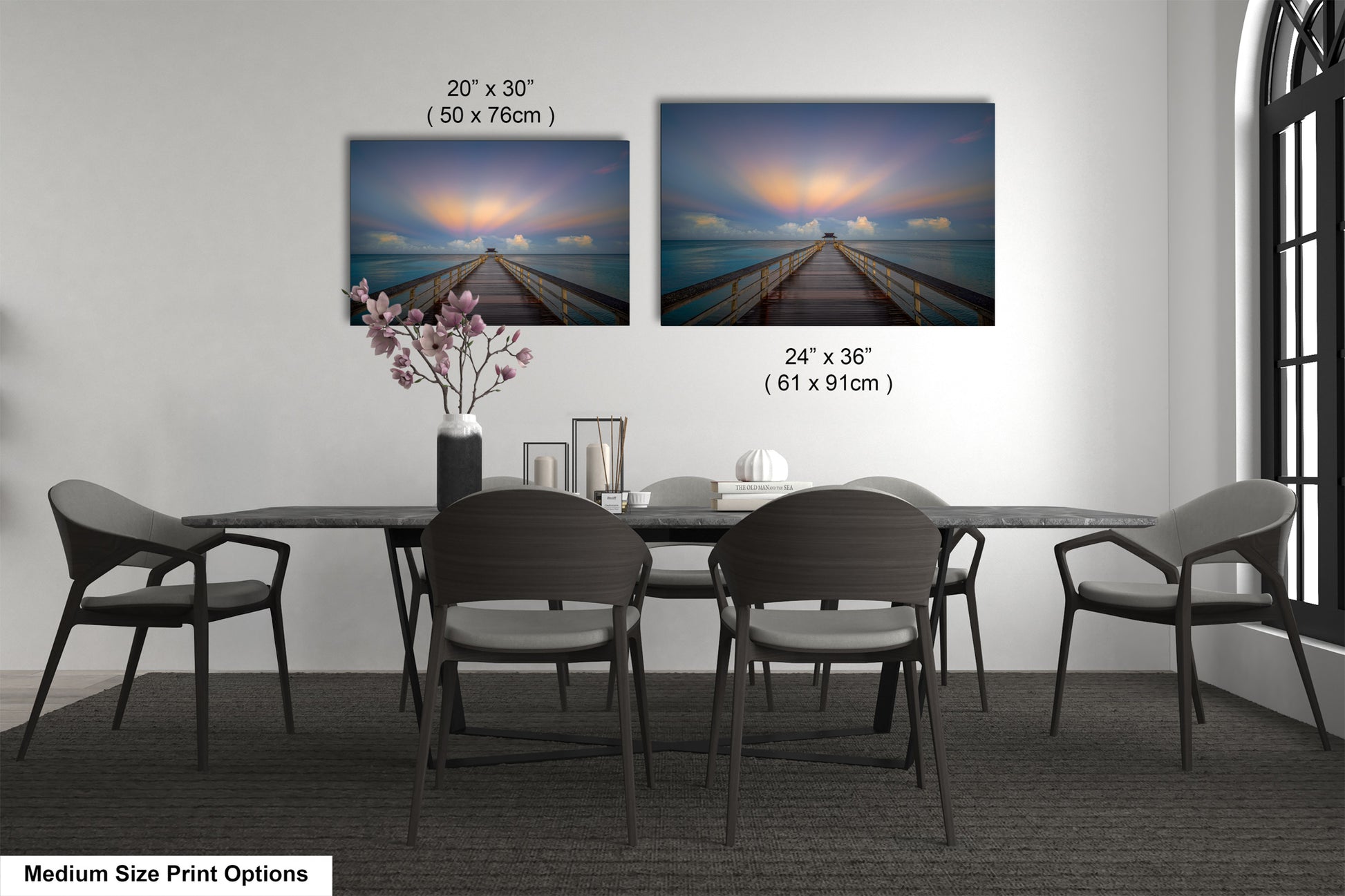 a dining table with four chairs and a vase of flowers