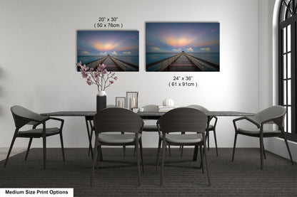 a dining table with four chairs and a vase of flowers