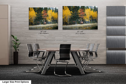 a dining room table with chairs and two pictures on the wall