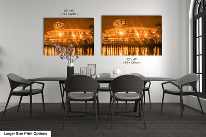 a dining room table with four chairs and a vase of flowers