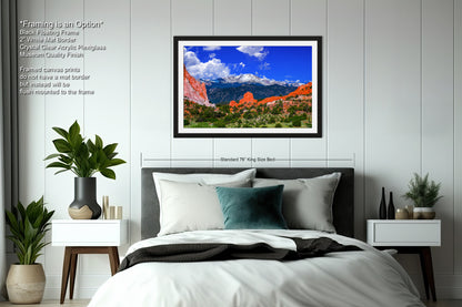 a bedroom with a bed and a picture hanging on the wall
