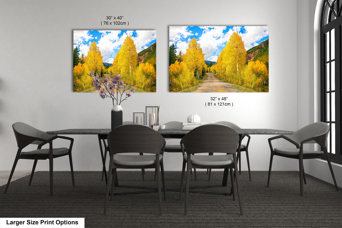 a dining room table with four chairs and two pictures on the wall