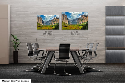 a dining room table with chairs and two pictures on the wall