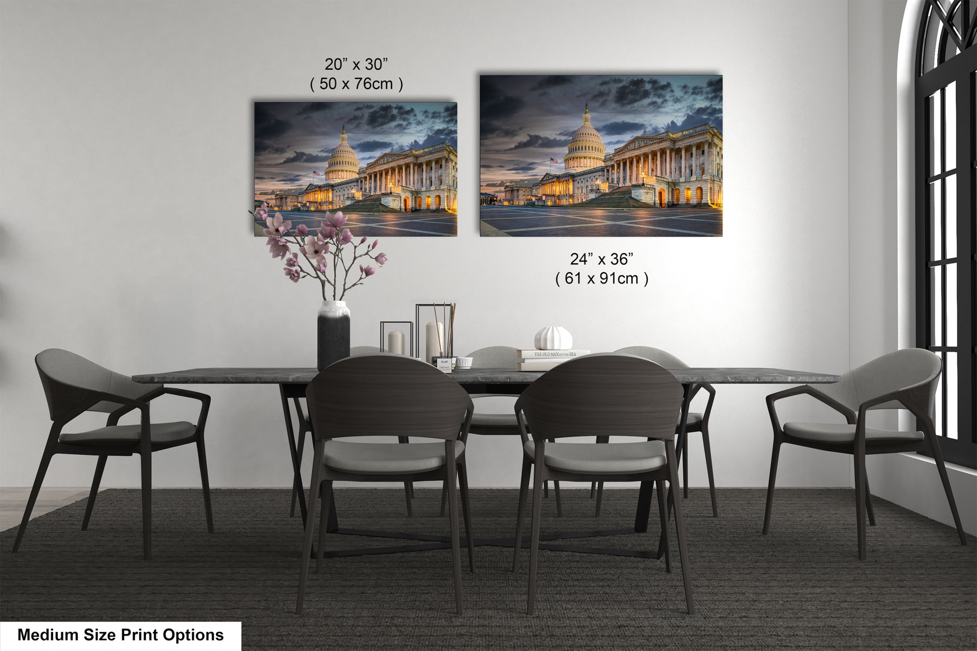 a dining table with four chairs and a vase of flowers