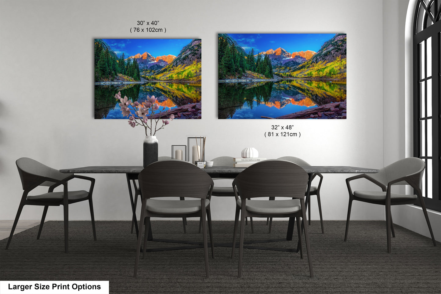a dining room table with chairs and a painting on the wall