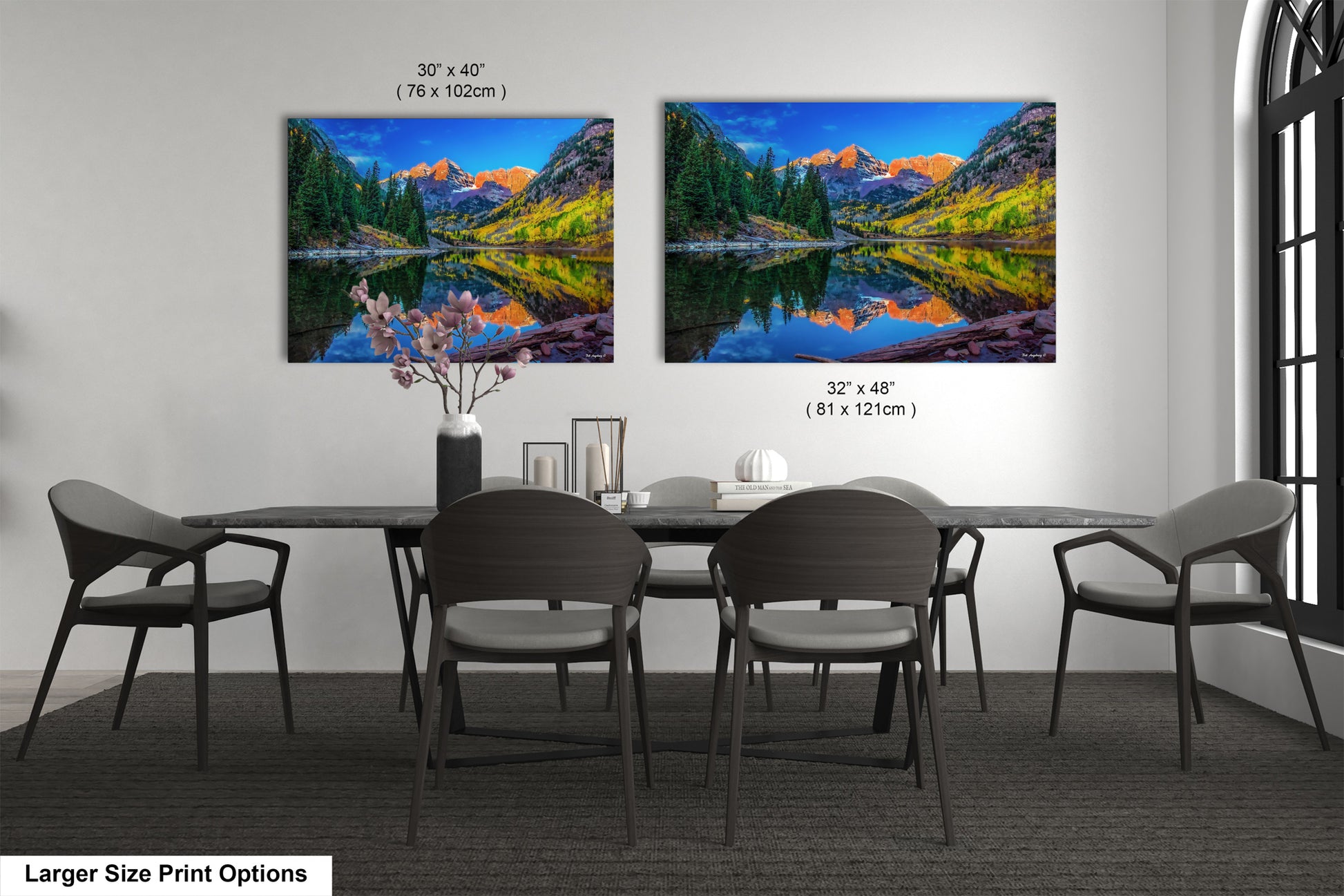 a dining room table with chairs and a painting on the wall