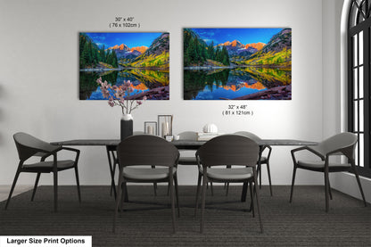 a dining room table with chairs and a painting on the wall