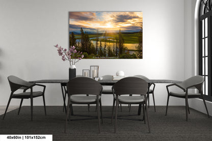 a dining room table with chairs and a painting on the wall