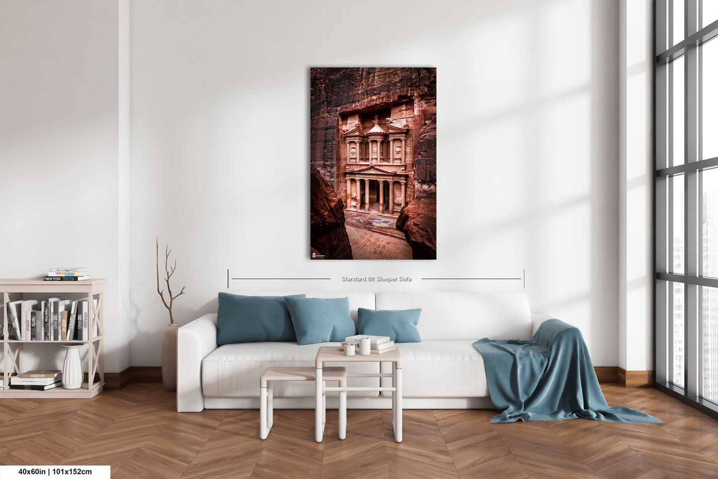 a living room with a white couch and a painting on the wall