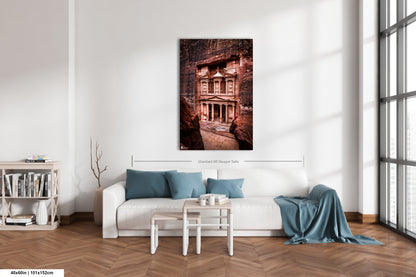 a living room with a white couch and a painting on the wall