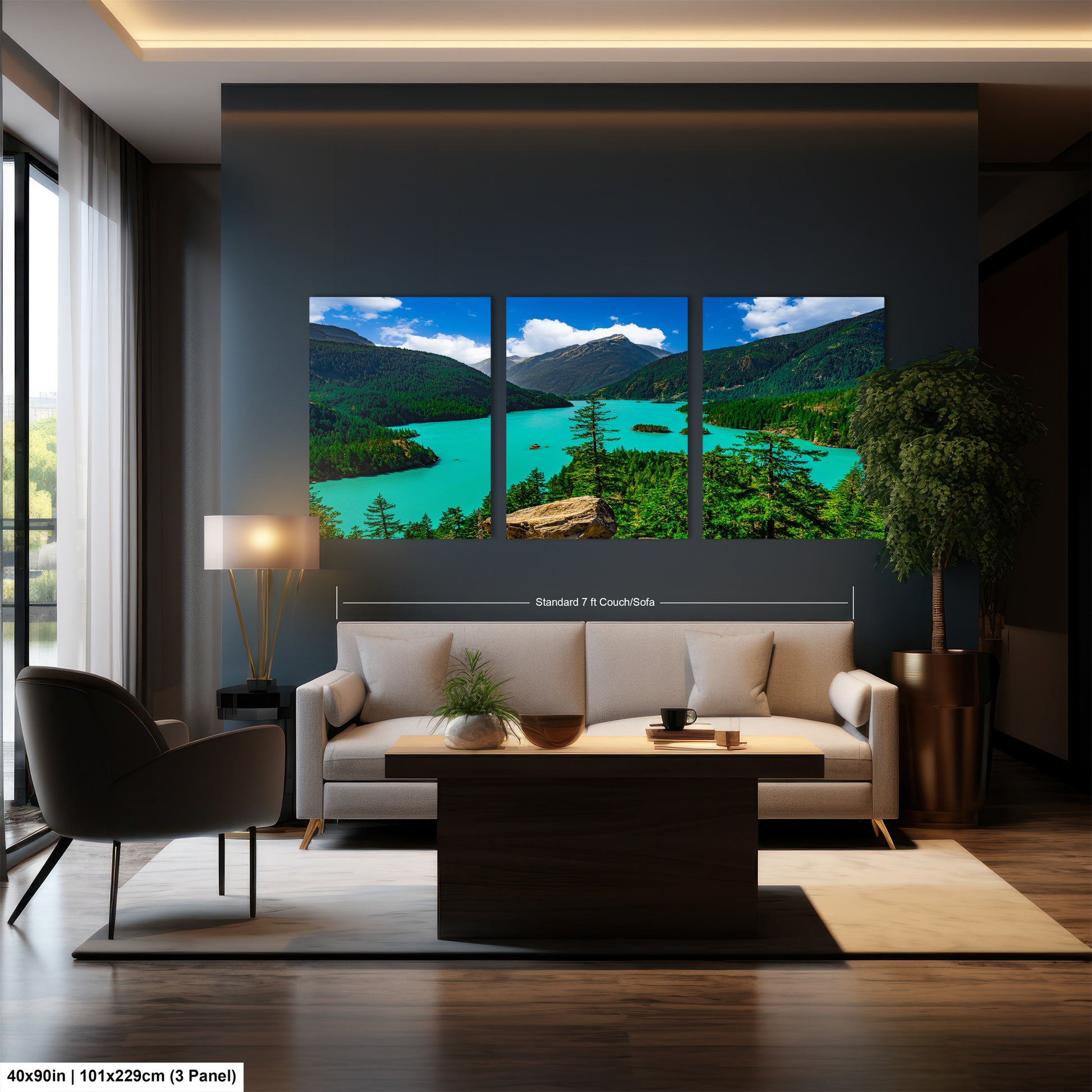 The image is a modern living room with a large, three-panel landscape painting depicting a scenic mountain lake. The painting is hung on the wall above a white sofa and a coffee table. The room also features a large window, a potted plant, and a rug on the wooden floor.