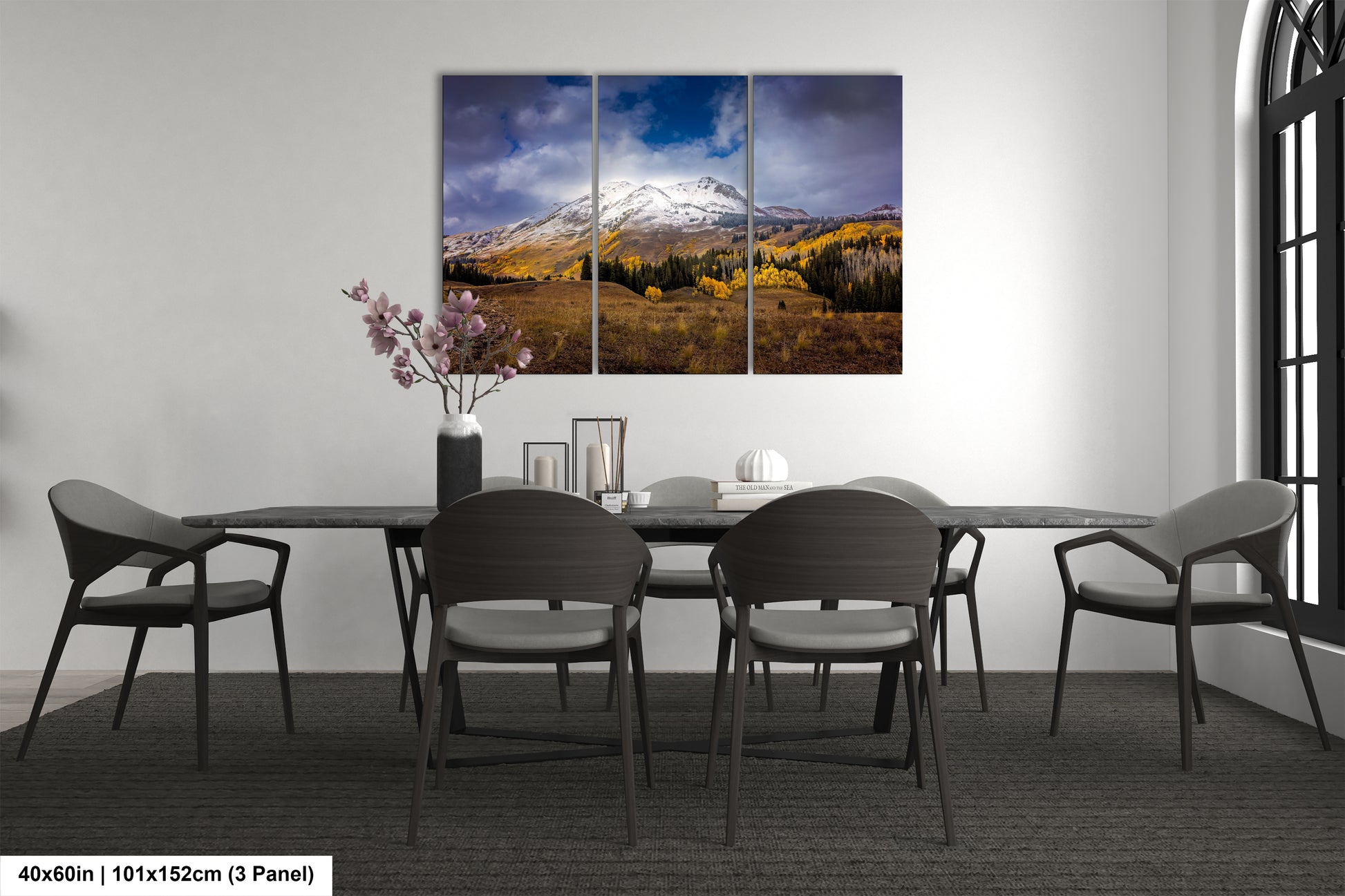 a dining room table with four chairs and a mountain in the background