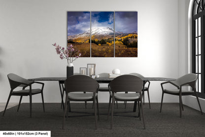 a dining room table with four chairs and a mountain in the background
