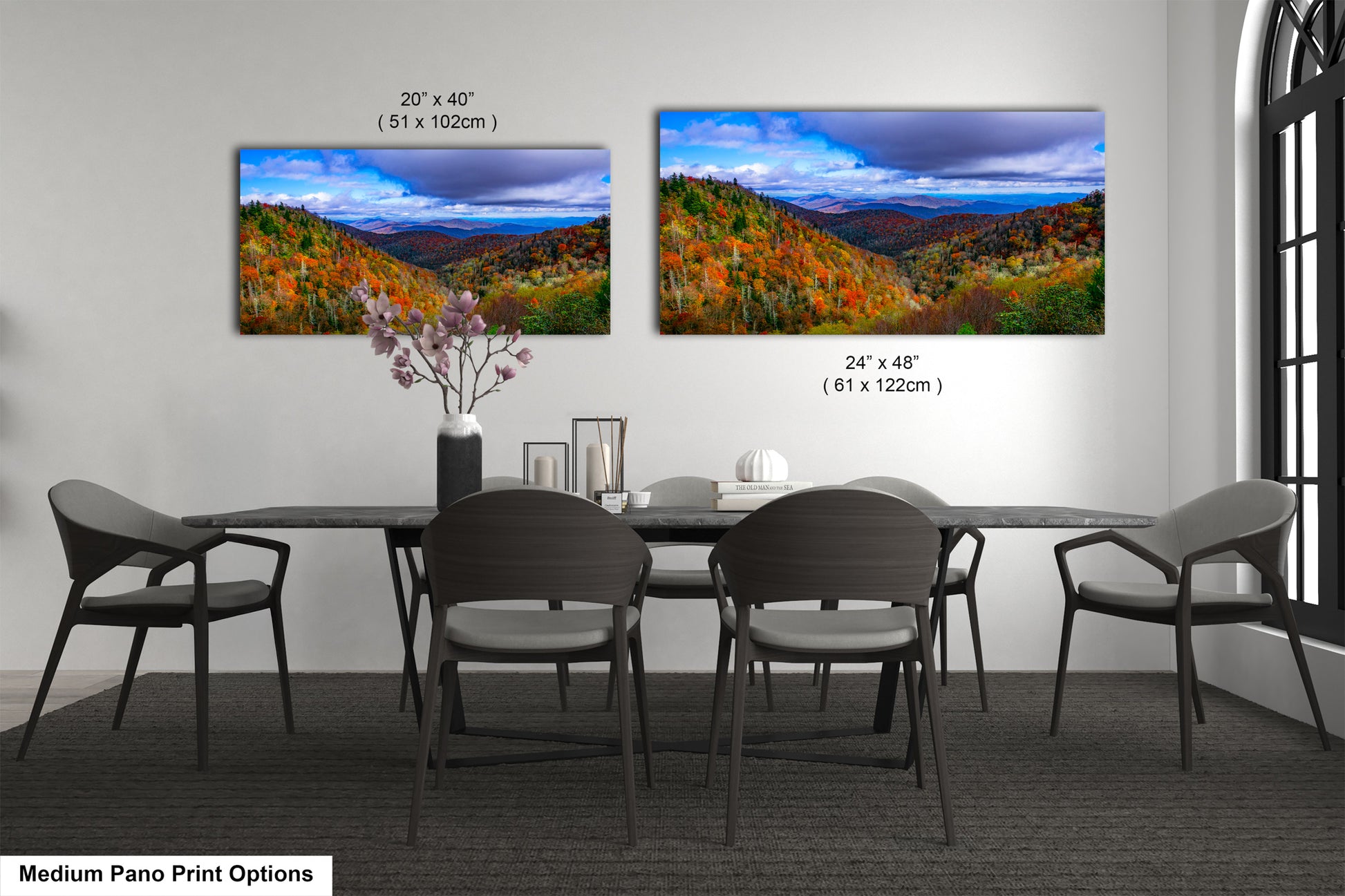 a dining room table with four chairs and a painting on the wall