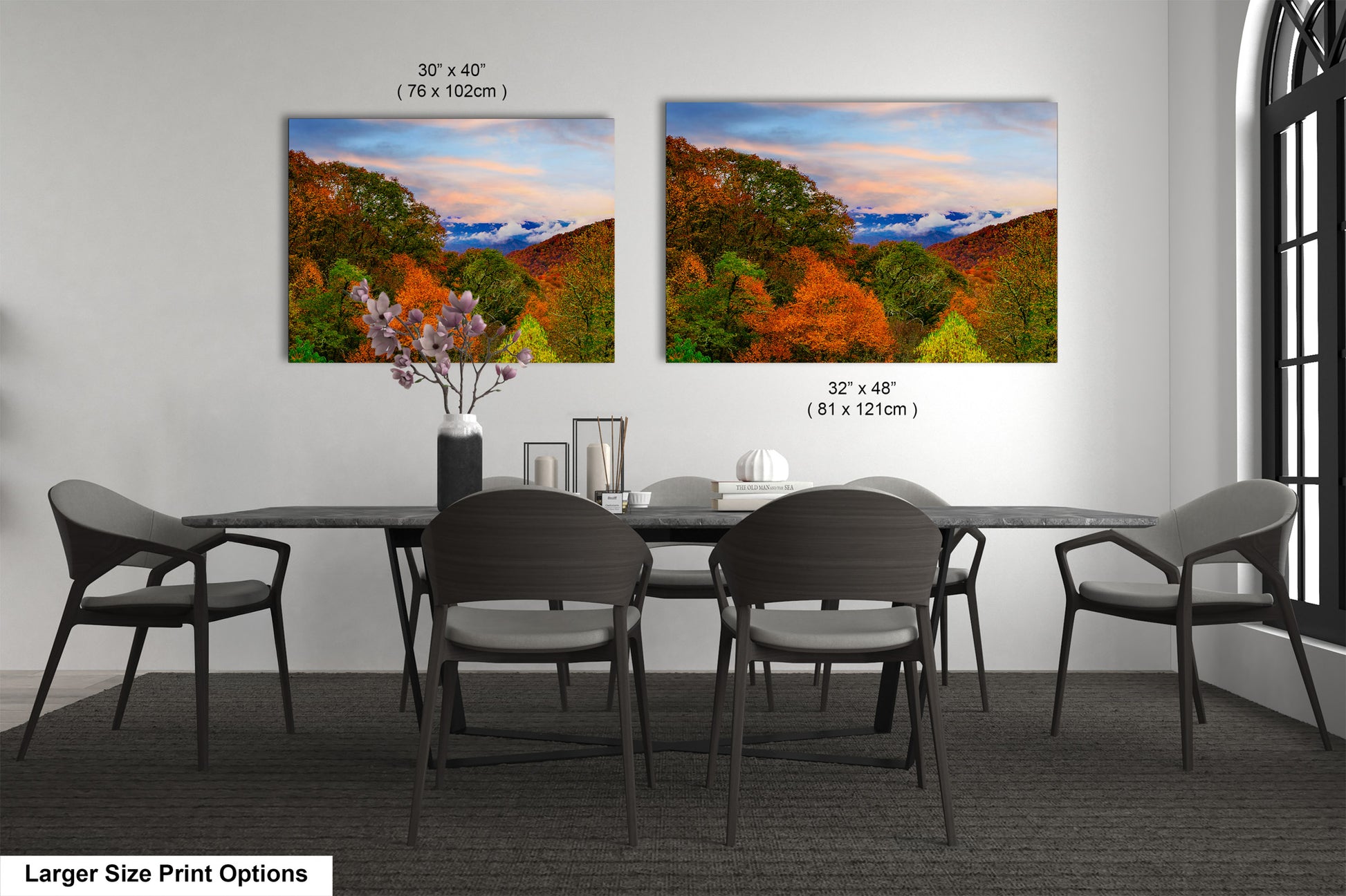 a dining room table with four chairs and two pictures on the wall