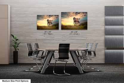 a dining room table with chairs and two pictures on the wall
