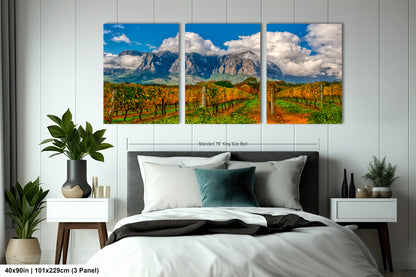 a bed room with a neatly made bed and two paintings on the wall
