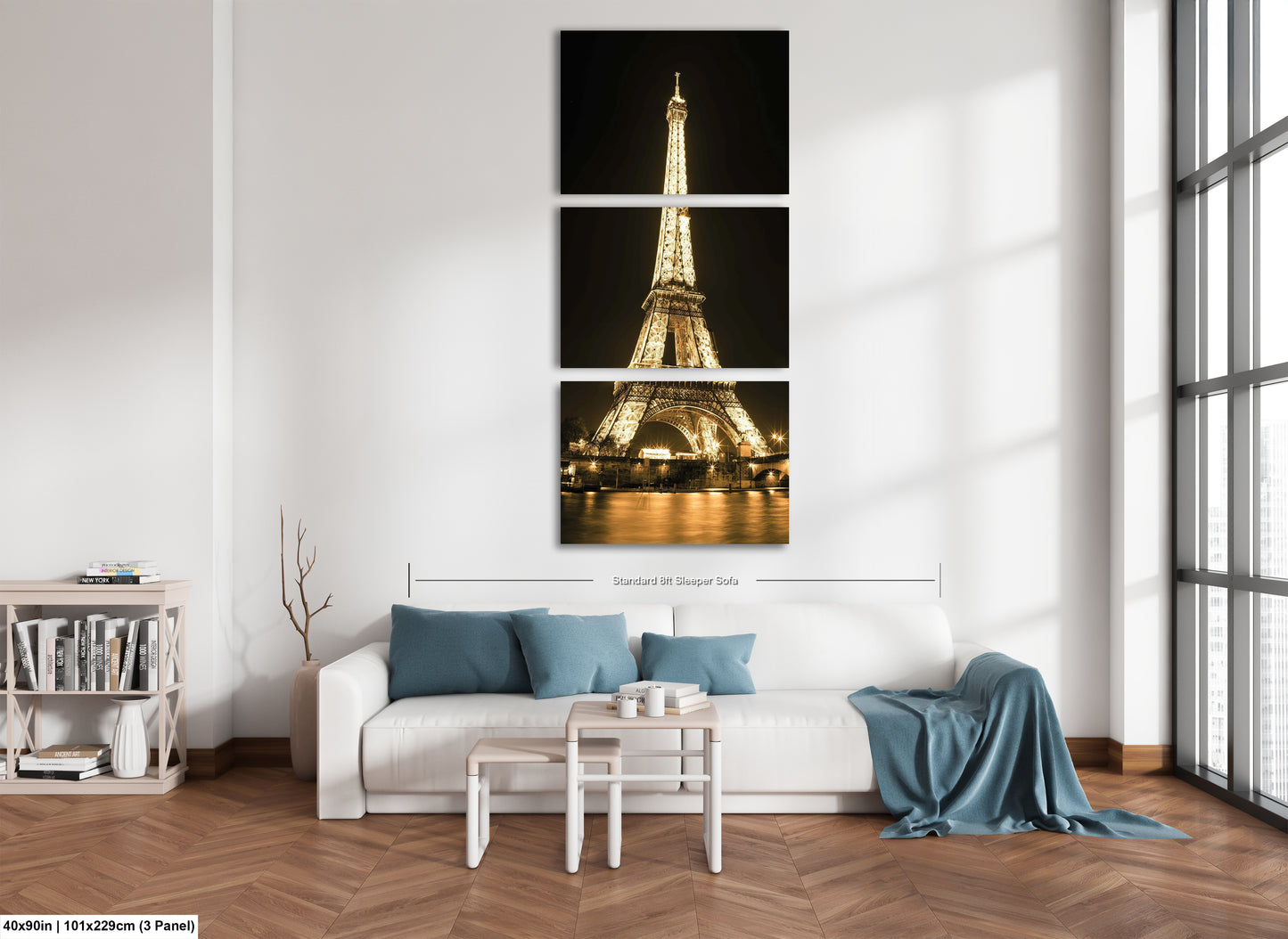 a living room with a white couch and three pictures of the eiffel tower