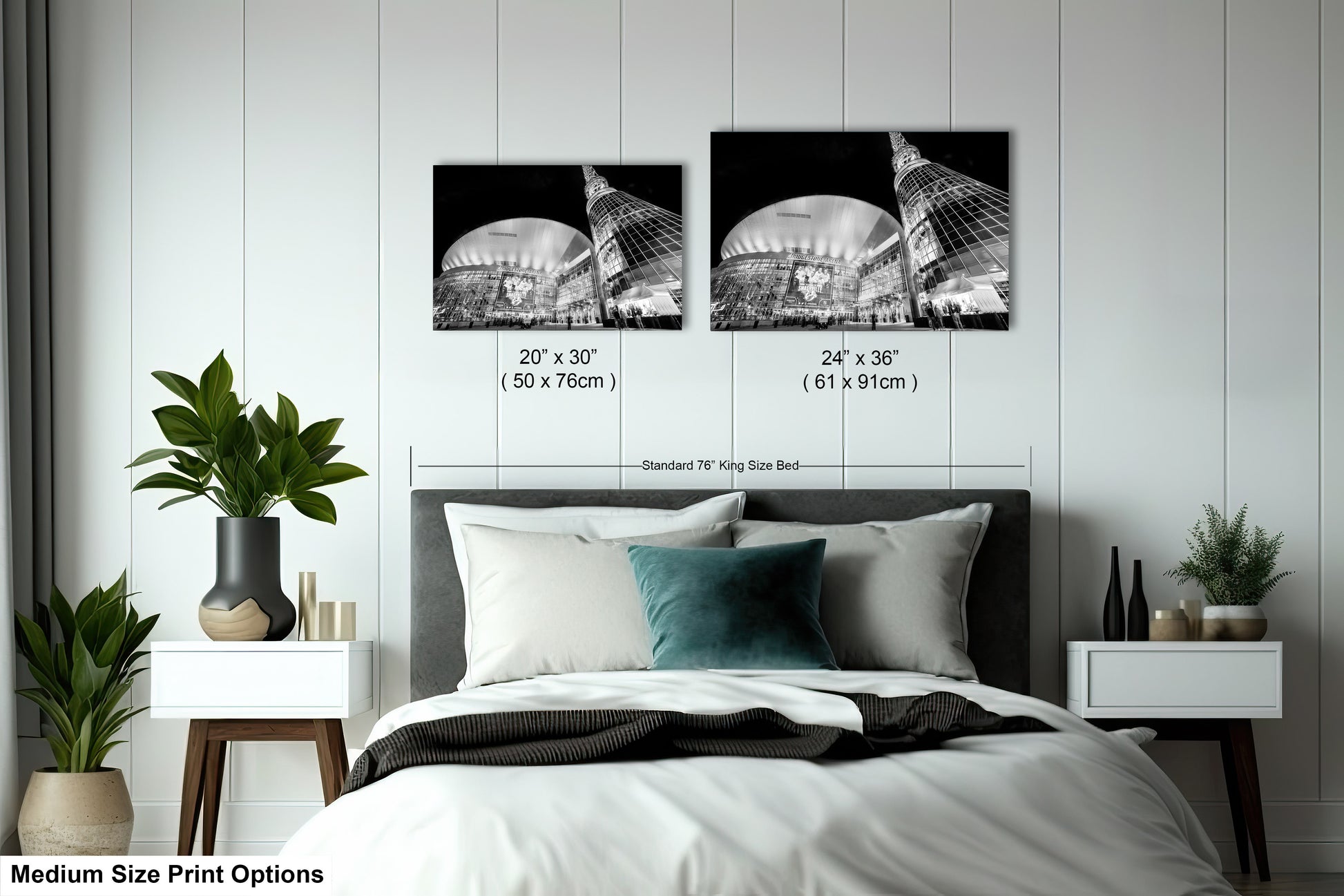 a bed with a white comforter and two black and white pictures on the wall