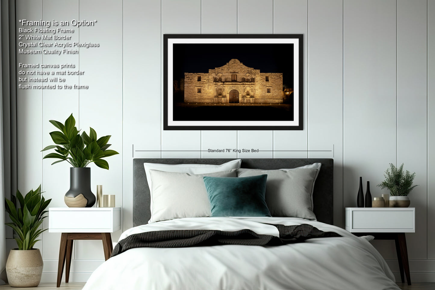a bedroom with a large framed photograph of a building, a bed with white bedding, and various decorative elements such as potted plants and vases.
