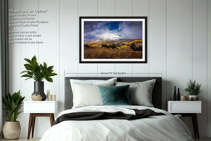 a bedroom with a bed and a picture hanging on the wall