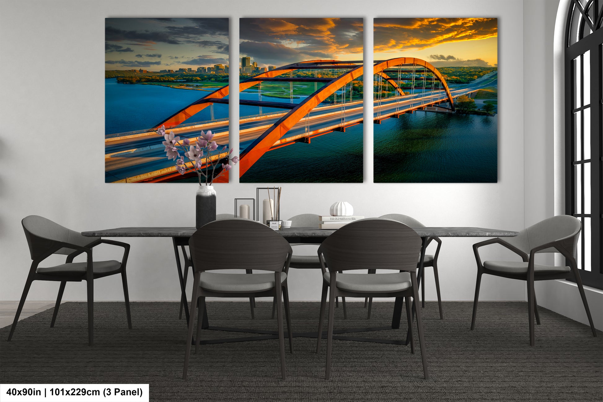 a dining room table with chairs and a painting on the wall