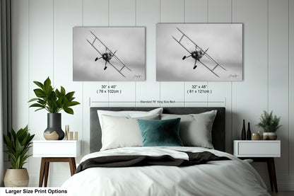 a bedroom with a bed and two pictures on the wall