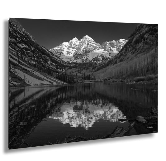 a black and white photo of a mountain lake