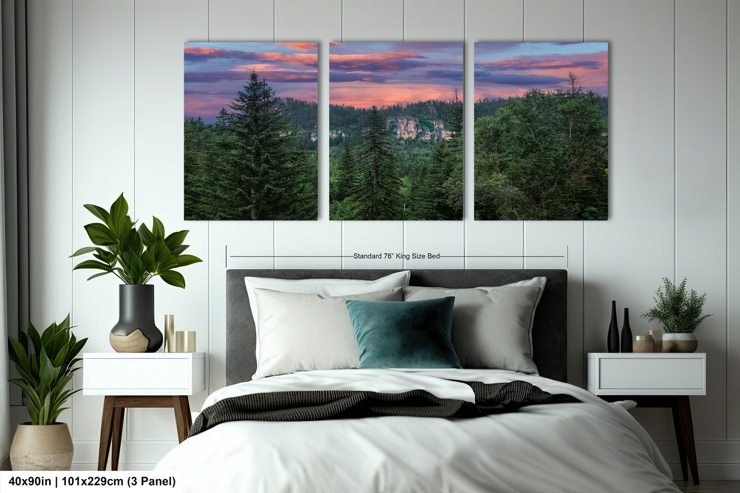 a bedroom with a bed and two paintings on the wall