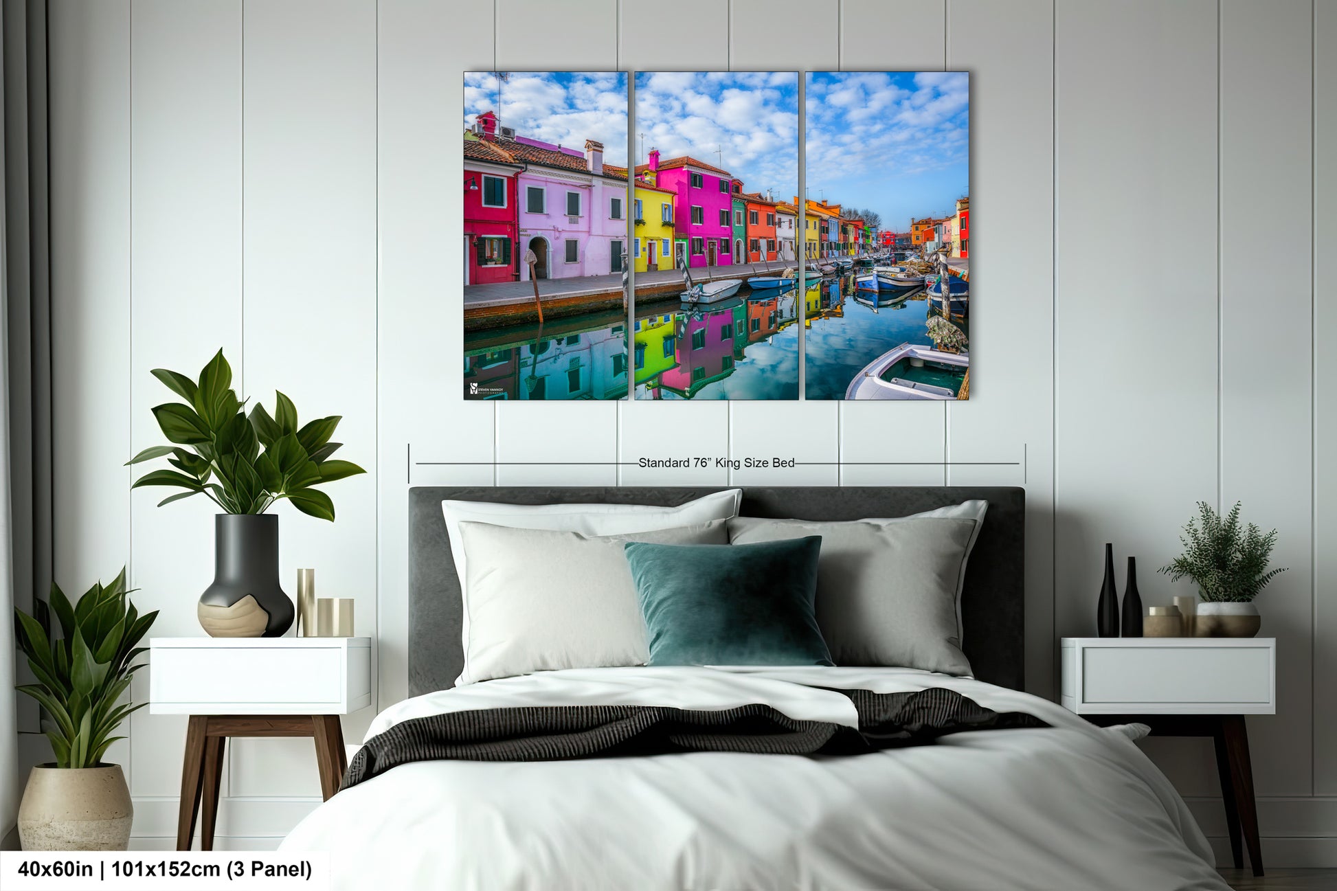 a bed room with a neatly made bed and a painting on the wall